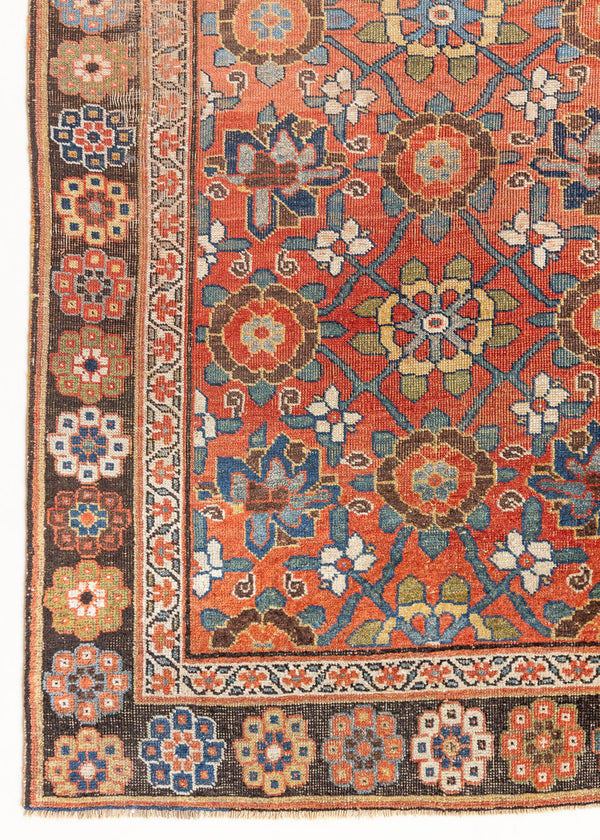An antique Persian Bijar runner rug in rich rust with blue and ivory