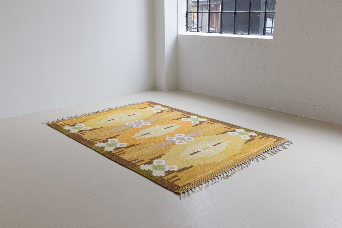 A Vintage Swedish kilim Rug by Ingegerd Silow. An original röllakan flatweave carpet featuring a yellow field and unique geometric design. 