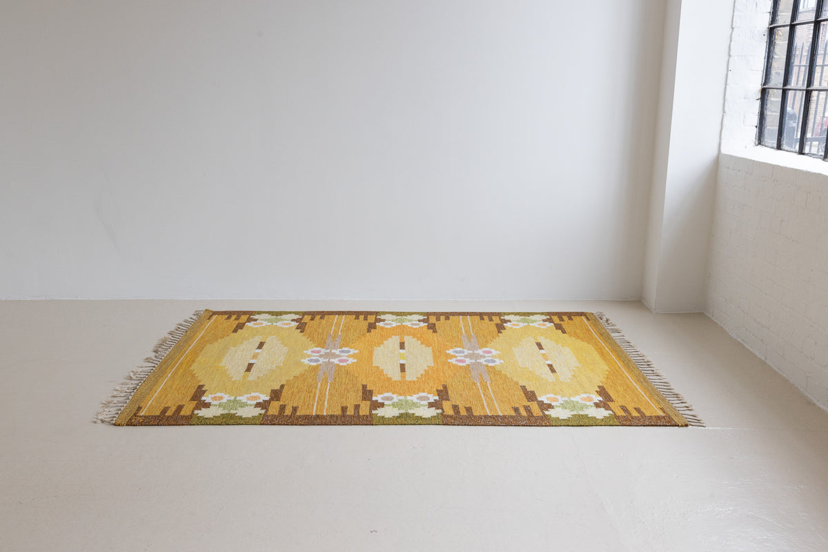 A Vintage Swedish kilim Rug by Ingegerd Silow. An original röllakan flatweave carpet featuring a yellow field and unique geometric design. 