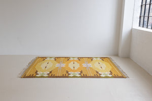 A Vintage Swedish kilim Rug by Ingegerd Silow. An original röllakan flatweave carpet featuring a yellow field and unique geometric design. 