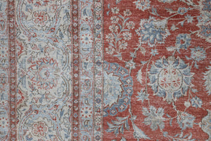 This is an antique Persian Kashan handwoven carpet in blue red and ivory tones. This vintage handmade wool rug features an all over floral design.