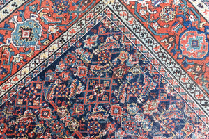 Vita is a beautiful Mahal rug featuring a navy blue field and a decorative all over Herati floral design, framed by a soft rust boarder. Mahal carpets are some of the most desirable Persian village rugs, often sought after by interior designers and collectors.