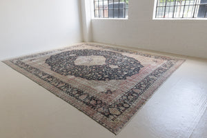 This is an large antique Persian Mahal handwoven carpet in a deep navy blue and a pinky red with ivory tones. This vintage hand woven wool rug features a all over floral design.