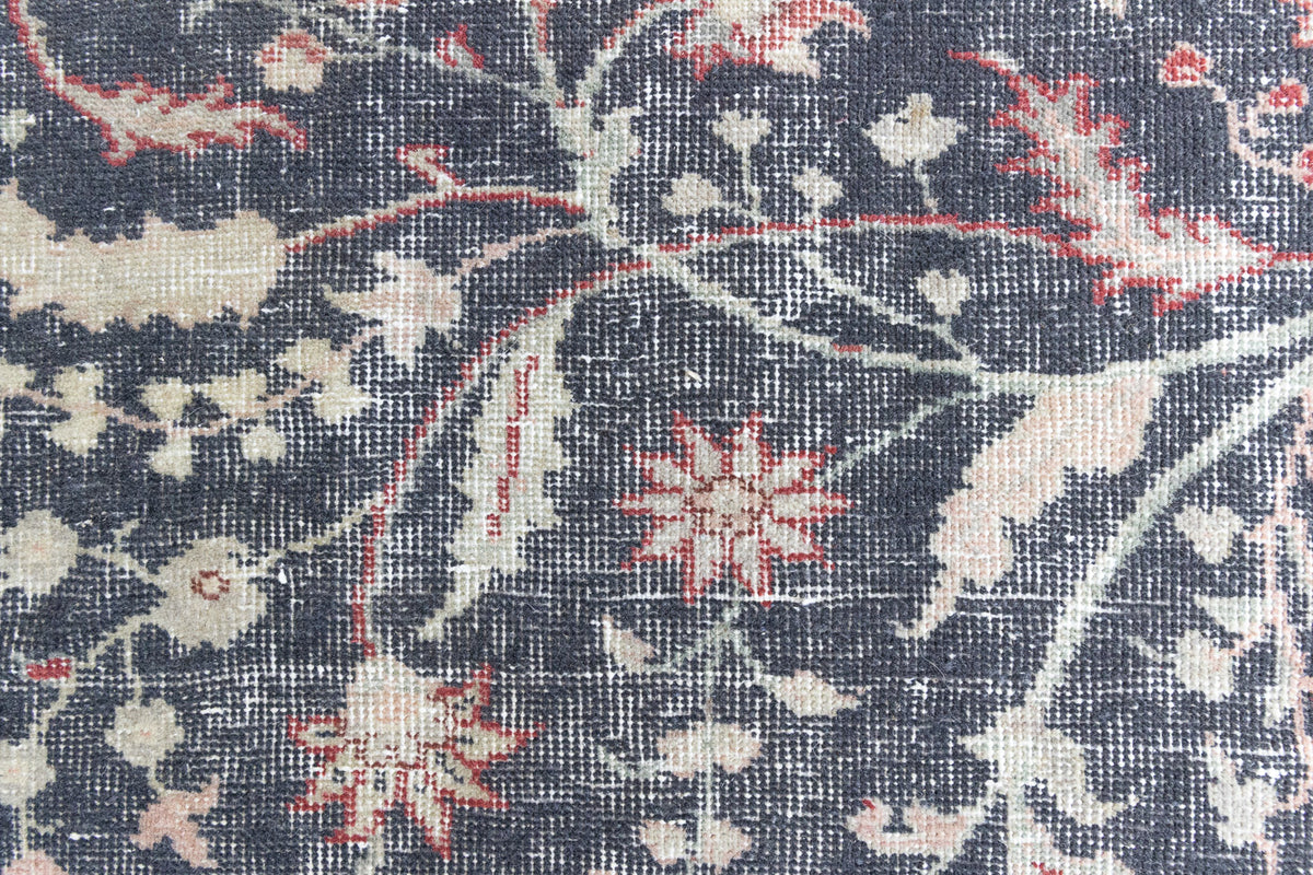 This is an large antique Persian Mahal handwoven carpet in a deep navy blue and a pinky red with ivory tones. This vintage hand woven wool rug features a all over floral design.