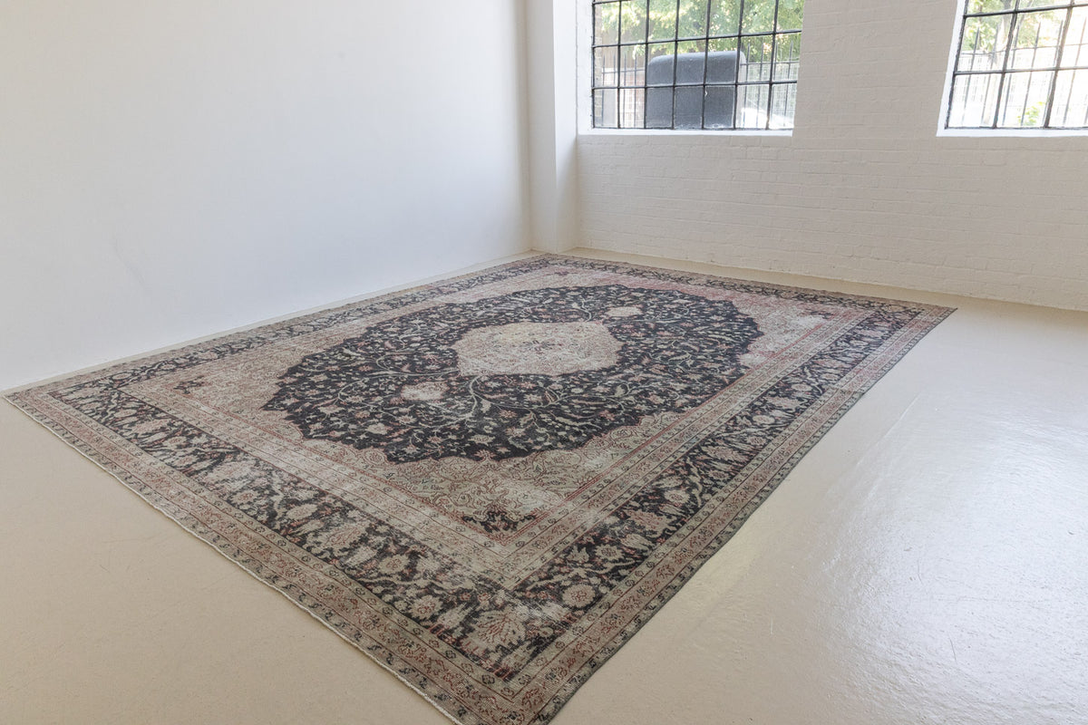 This is an large antique Persian Mahal handwoven carpet in a deep navy blue and a pinky red with ivory tones. This vintage hand woven wool rug features a all over floral design.