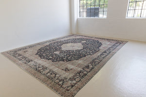 This is an large antique Persian Mahal handwoven carpet in a deep navy blue and a pinky red with ivory tones. This vintage hand woven wool rug features a all over floral design.