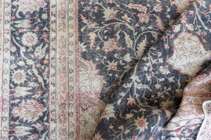 This is an large antique Persian Mahal handwoven carpet in a deep navy blue and a pinky red with ivory tones. This vintage hand woven wool rug features a all over floral design.