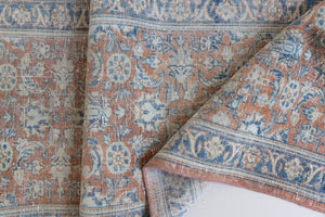 This is an large antique Persian Mahal runner handwoven carpet in a rusty orange red  and muted blue with ivory tones. This vintage hand woven wool rug features a all over floral design.