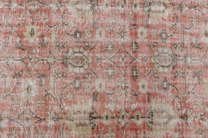 This is an large antique Turkish handwoven carpet in a rusty orange red  and muted blue with ivory tones. This vintage hand woven wool rug features a all over floral design.