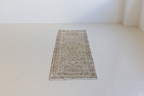 A vintage Persian Heriz runner. Heriz rugs are some of the most sought after Persian carpets and this one features a classic Karaja design in soft taupe and chocolate brown tones with sage green accents.