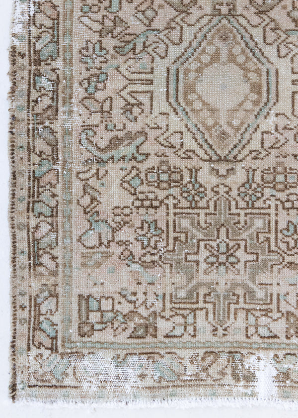 A vintage Persian Heriz runner. Heriz rugs are some of the most sought after Persian carpets and this one features a classic Karaja design in soft taupe and chocolate brown tones with sage green accents.
