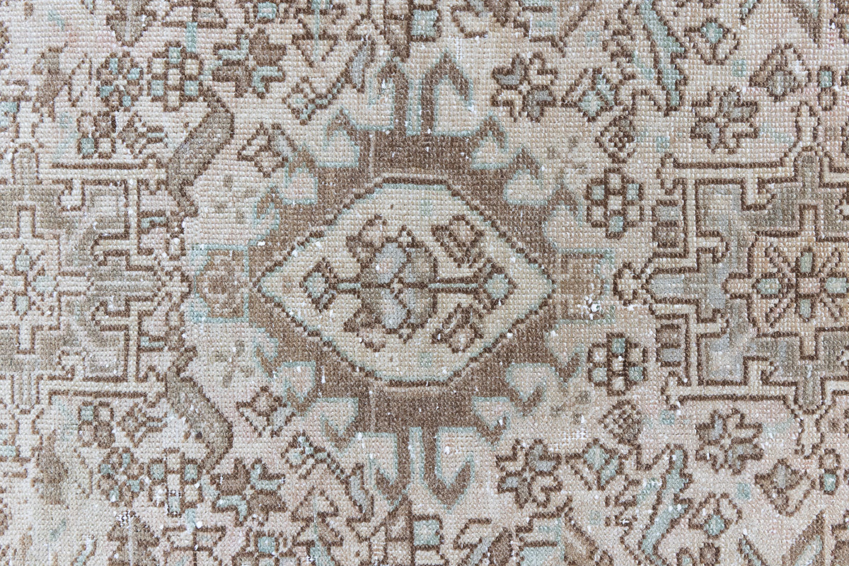Close up of a vintage Persian Heriz runner. Heriz rugs are some of the most sought after Persian carpets and this one features a classic Karaja design in soft taupe and chocolate brown tones with sage green accents.