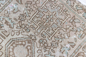 A vintage Persian Heriz runner. Heriz rugs are some of the most sought after Persian carpets and this one features a classic Karaja design in soft taupe and chocolate brown tones with sage green accents.