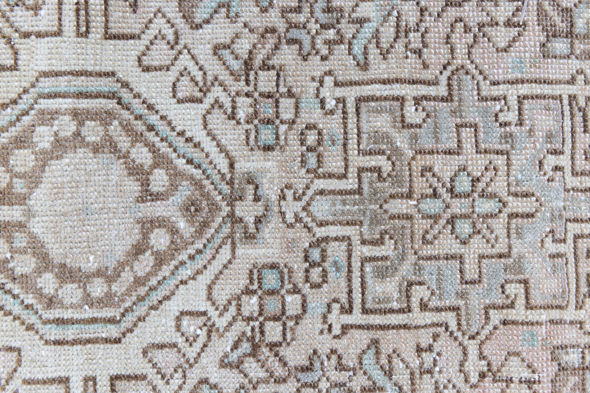 A vintage Persian Heriz runner. Heriz rugs are some of the most sought after Persian carpets and this one features a classic Karaja design in soft taupe and chocolate brown tones with sage green accents.