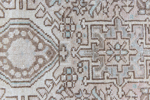 A vintage Persian Heriz runner. Heriz rugs are some of the most sought after Persian carpets and this one features a classic Karaja design in soft taupe and chocolate brown tones with sage green accents.