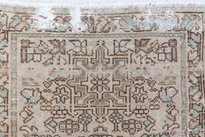 A vintage Persian Heriz runner. Heriz rugs are some of the most sought after Persian carpets and this one features a classic Karaja design in soft taupe and chocolate brown tones with sage green accents.