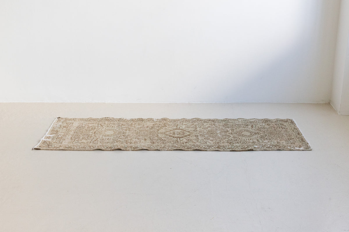 A vintage Persian Heriz runner. Heriz rugs are some of the most sought after Persian carpets and this one features a classic Karaja design in soft taupe and chocolate brown tones with sage green accents.