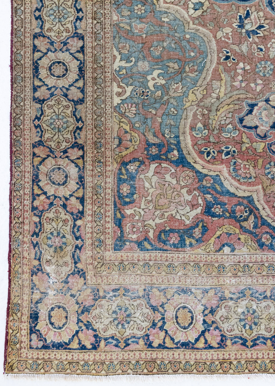 Celeste is a beautiful antique Persian Tabriz rug with a soft pink and blue colour palette and a lovely floral central medallion. This piece is attributed to the master Hadji Jalili workshop which produced some of the most refined Persian carpets of the 19th century, known for their soft tones, intricate medallions, and balanced designs.