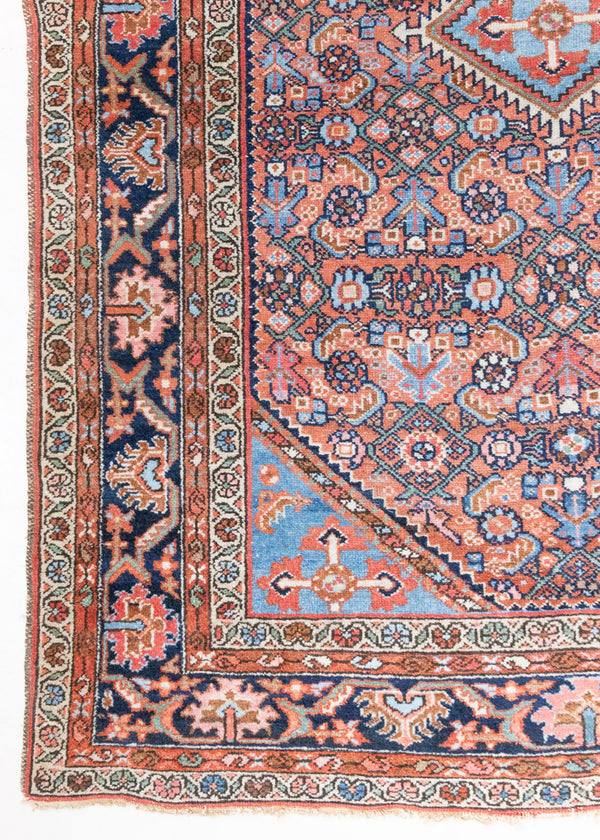 An antique Persian Malayer rug, woven in the north west of Iran. This pretty Persian handwoven carpet features a fine all-over pattern in soft pink, dusty blue and navy. The Malayer region is known for producing some of the most ornate Persian rugs, often known for their mesmerising and intricate patterns.