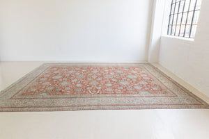 This is an antique Persian Kashan handwoven carpet in blue red and ivory tones. This handmade antique rug features an all over floral design.