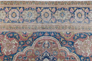 Celeste is a beautiful antique Persian Tabriz rug with a soft pink and blue colour palette and a lovely floral central medallion. This piece is attributed to the master Hadji Jalili workshop which produced some of the most refined Persian carpets of the 19th century, known for their soft tones, intricate medallions, and balanced designs.
