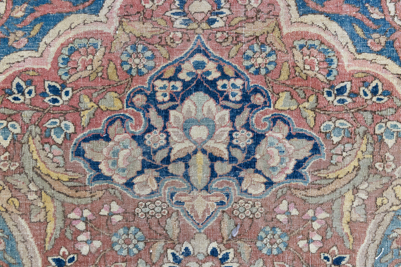Celeste is a beautiful antique Persian Tabriz rug with a soft pink and blue colour palette and a lovely floral central medallion. This piece is attributed to the master Hadji Jalili workshop which produced some of the most refined Persian carpets of the 19th century, known for their soft tones, intricate medallions, and balanced designs.