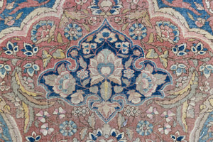 Celeste is a beautiful antique Persian Tabriz rug with a soft pink and blue colour palette and a lovely floral central medallion. This piece is attributed to the master Hadji Jalili workshop which produced some of the most refined Persian carpets of the 19th century, known for their soft tones, intricate medallions, and balanced designs.