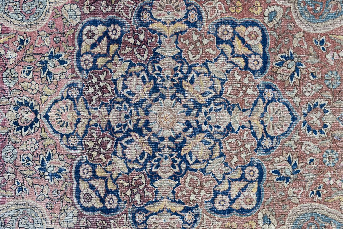 Celeste is a beautiful antique Persian Tabriz rug with a soft pink and blue colour palette and a lovely floral central medallion. This piece is attributed to the master Hadji Jalili workshop which produced some of the most refined Persian carpets of the 19th century, known for their soft tones, intricate medallions, and balanced designs.
