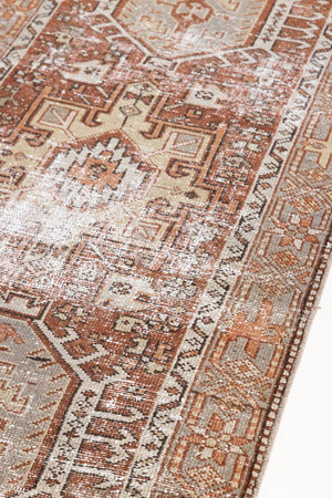 Detail of a genuine antique Persian Heriz runner in red and green tones, a handmade carpet with a Karaja design.