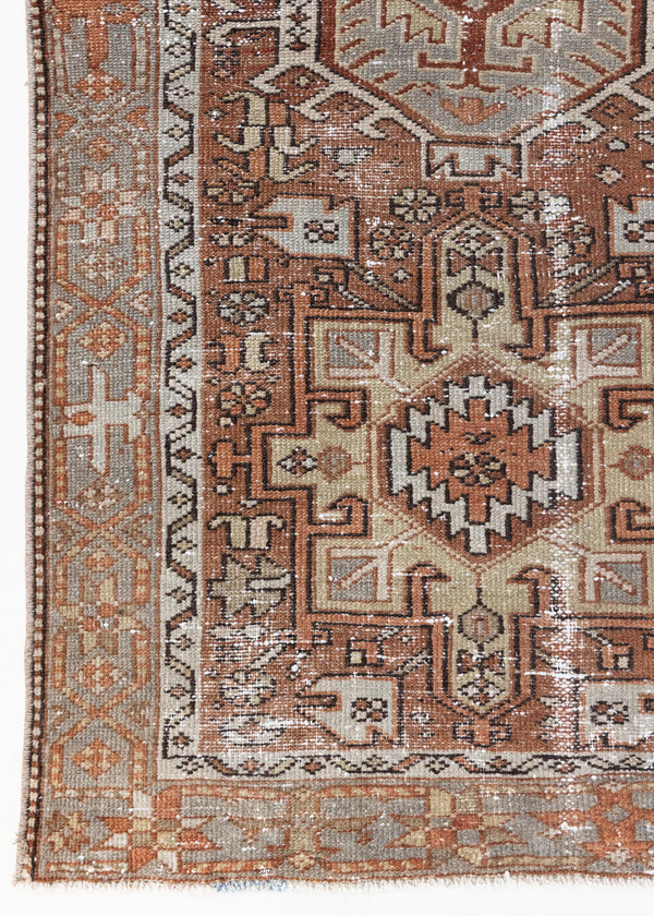 This is an antique Persian Heriz runner, a handmade rug in red and green tones, featuring a Karaja design.
