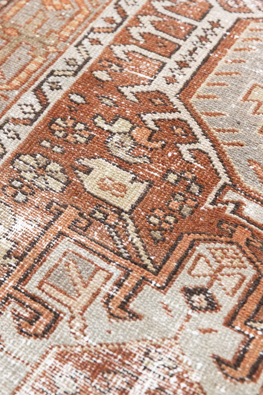 A vintage Persian Heriz runner in red and green tones — this hand-knotted antique carpet showcases a Karaja design.