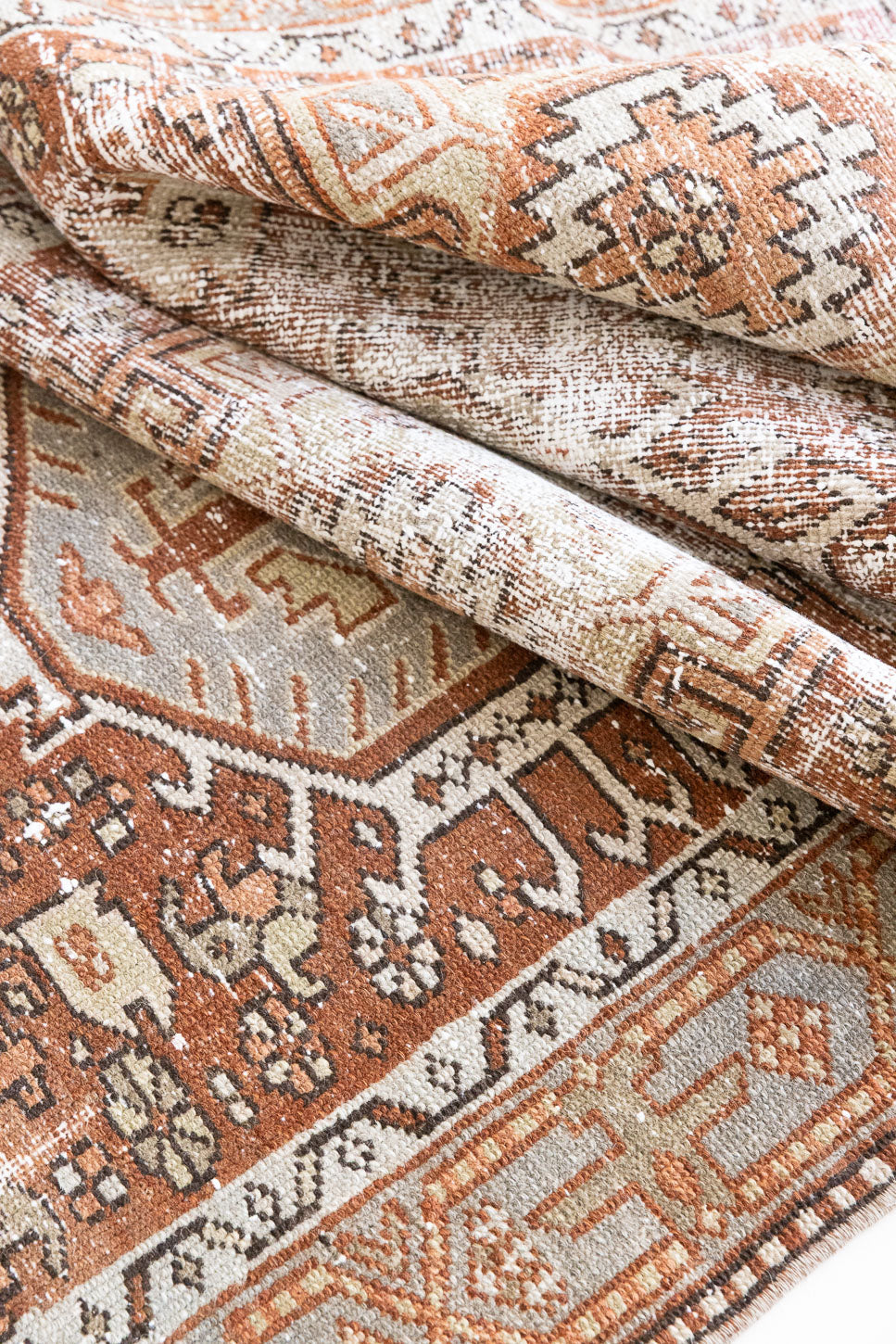 A vintage Persian Heriz runner in red and green tones — this hand-knotted antique carpet showcases a Karaja design.