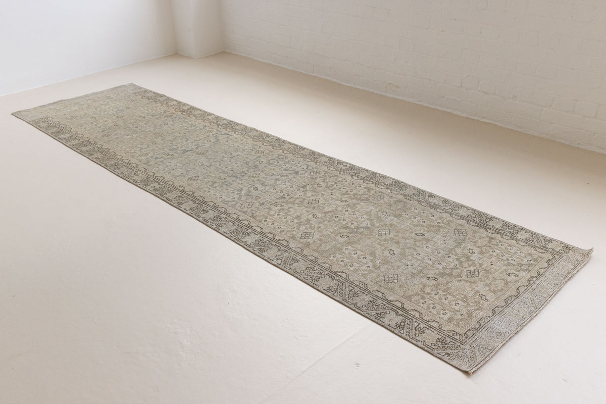 This is an antique Persian Malayer runner, a handmade rug in blue tones, featuring an all-over design.