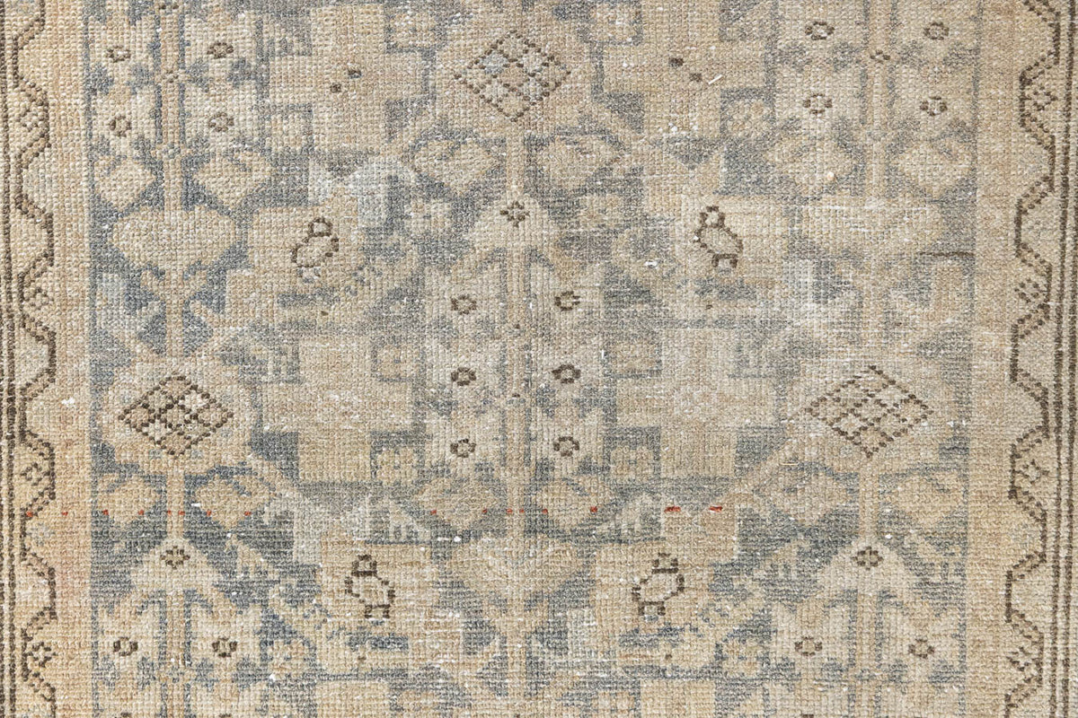 Detail of a genuine antique Persian Malayer runner in blue tones, a handmade carpet with an all-over design.