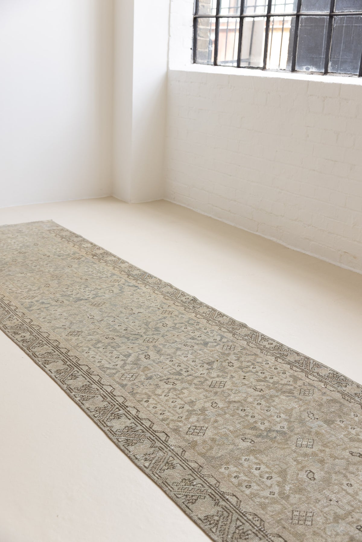 This is an antique Persian Malayer runner, a handmade rug in blue tones, featuring an all-over design.