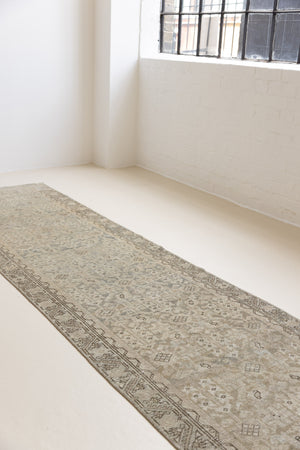This is an antique Persian Malayer runner, a handmade rug in blue tones, featuring an all-over design.