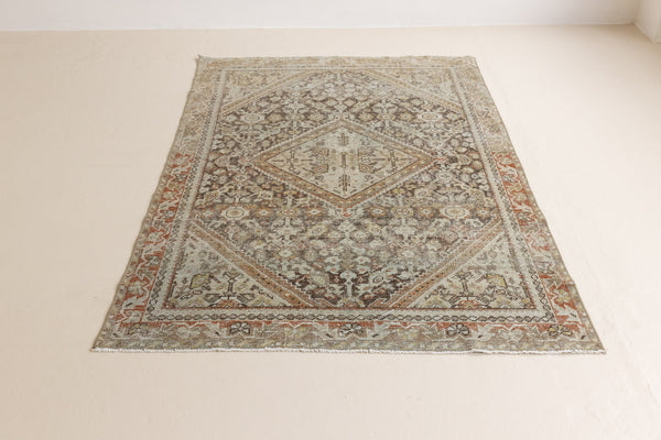 A vintage Persian Mahal carpet in neutral tones — this hand-knotted antique rug showcases an all-over floral design.