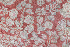Detail of a genuine antique Persian Sarouk carpet in red and blue tones, a handmade rug with a floral medallion design.