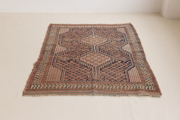 A vintage Persian Afshar carpet in red and blue tones — this hand-knotted antique rug showcases a geometric tribal design.