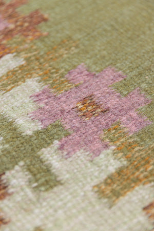 An original mid-century vintage Swedish flatweave rug in soft greens with accents of pink and rust
