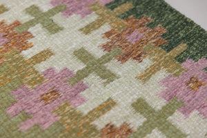 Vintage Swedish flatweave rug with a green field and geometric border, handwoven in wool