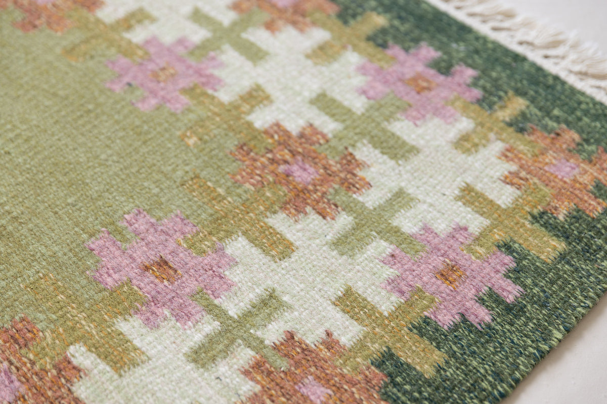 Vintage Swedish flatweave rug with a green field and geometric border, handwoven in wool