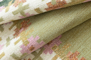 An original mid-century vintage Swedish flatweave rug in soft greens with accents of pink and rust