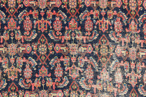 Raine is a beautiful antique Senneh rug with an intricate design. Senneh rugs are known for their fine and intricate patterns and distinctive weaving technique. Raine has a central motif surrounded by an intricate pattern and a pleasing colour palette of blue, red and taupe.