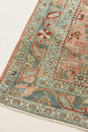 Celine is a beautiful Hamedan rug featuring a rusty pink field, blue border and a decorative all over floral design