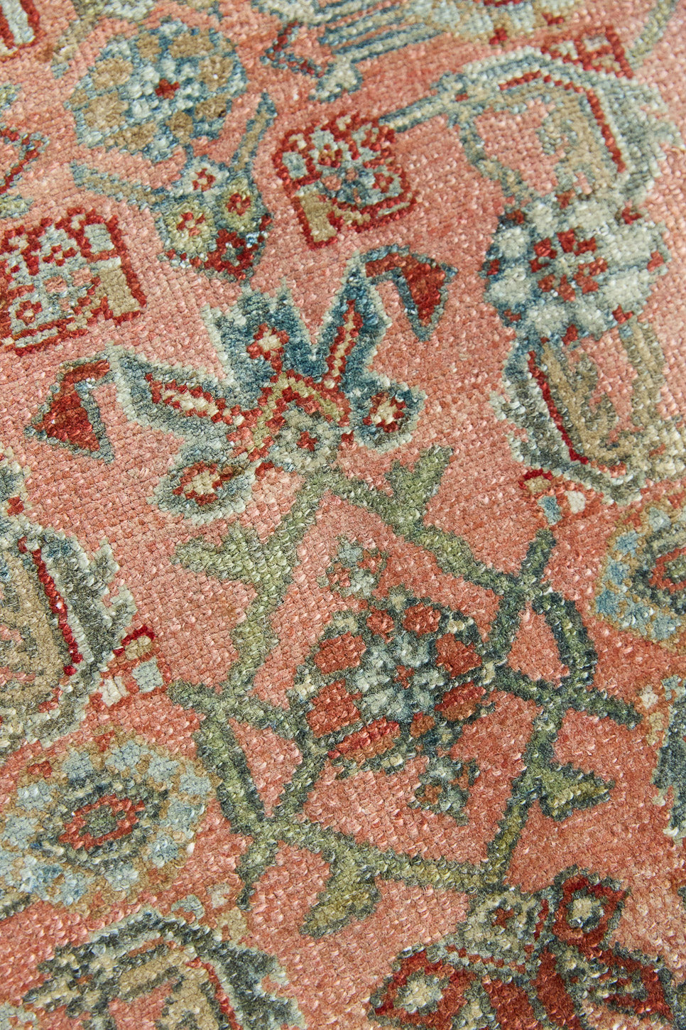 Celine is a beautiful Hamedan rug featuring a rusty pink field, blue border and a decorative all over floral design