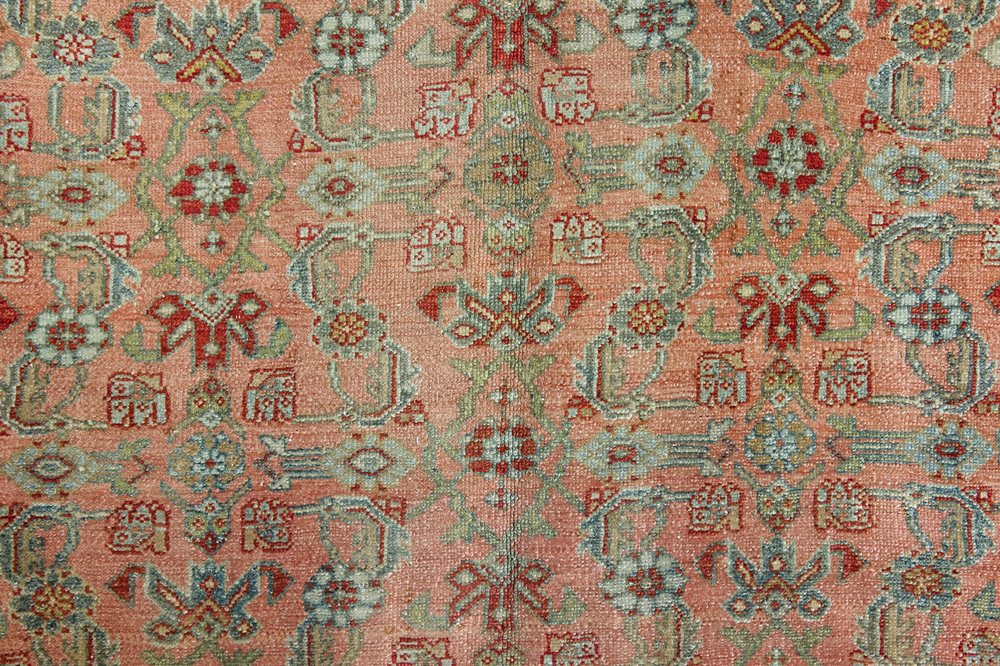 Celine is a beautiful Hamedan rug featuring a rusty pink field, blue border and a decorative all over floral design