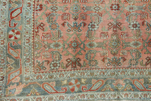 Celine is a beautiful Hamedan rug featuring a rusty pink field, blue border and a decorative all over floral design