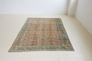 Celine is a beautiful Hamedan rug featuring a rusty pink field, blue border and a decorative all over floral design