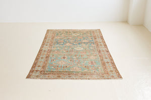Alina an antique Persian Malayer rug with a blue field and an earthy pink intricate all over floral design